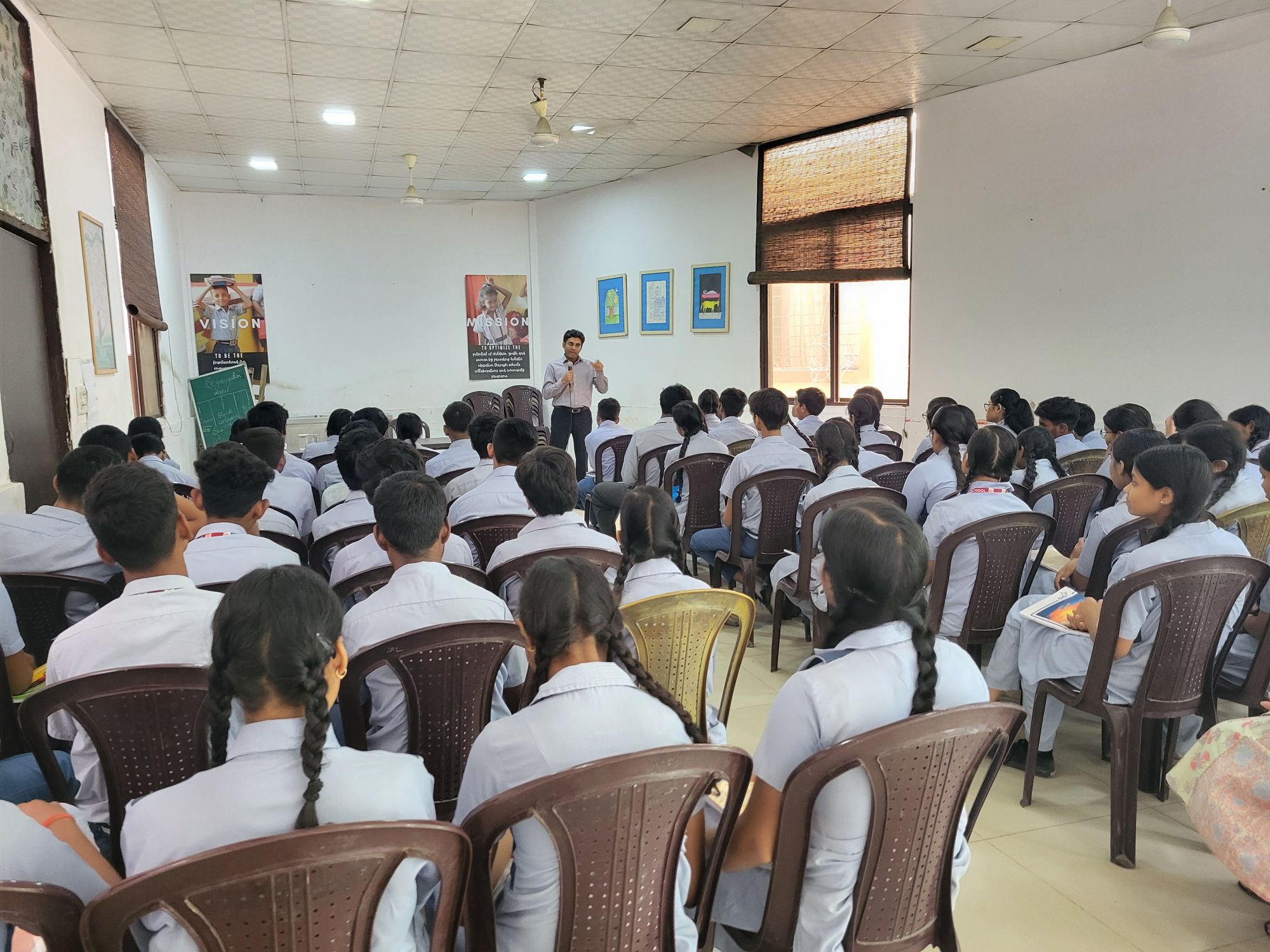 An ICRA volunteer addressing students at a school session